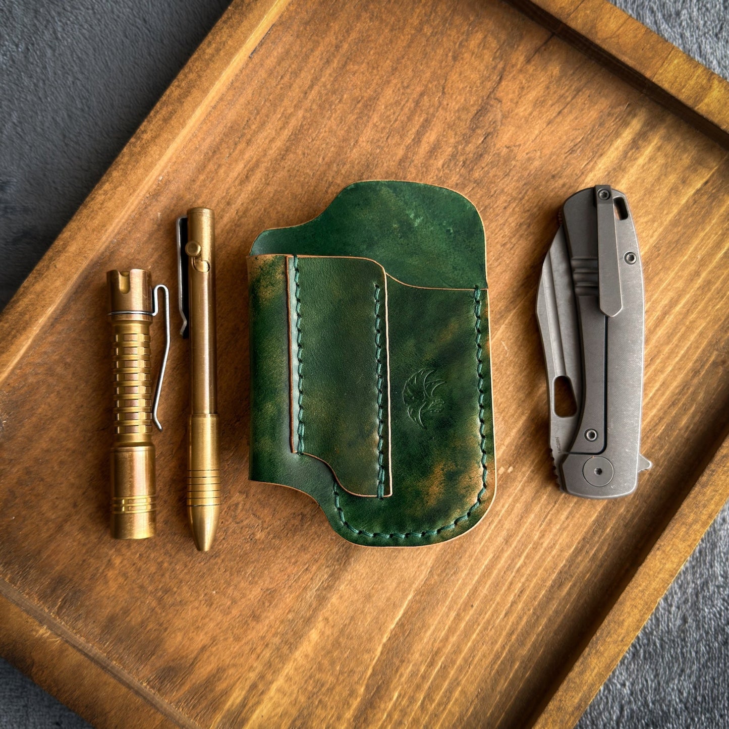 Handmade EDC pocket organizer crafted from genuine Green Marbled Rocado Shell Cordovan leather, featuring custom pockets for a folding knife, flashlight, and pen